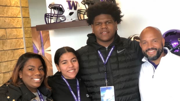 Josh Conerly and family members meet with UW coach Jimmy Lake.